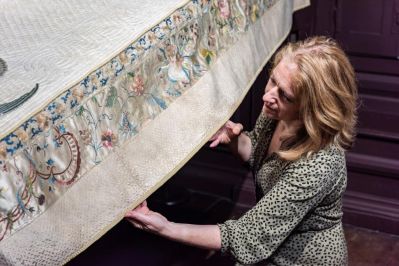 2_Erddig_Property_Curator_Susanne_Gronnow_examines_the_bed_cover._National_Trust_Images_Paul_Harris__-_Copy.jpg